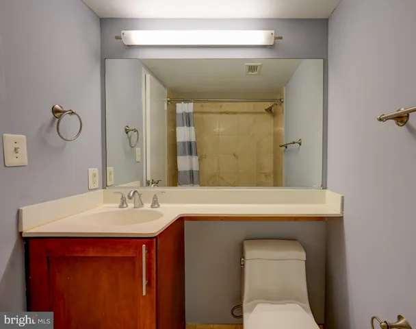 a bathroom with a sink a toilet and mirror