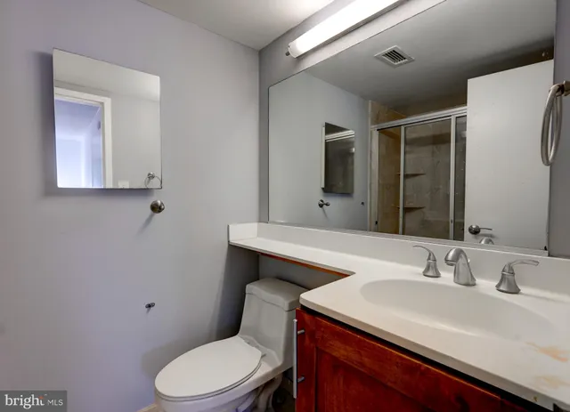 a bathroom with a sink toilet and mirror