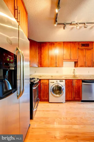 a kitchen with stainless steel appliances granite countertop a sink and a stove