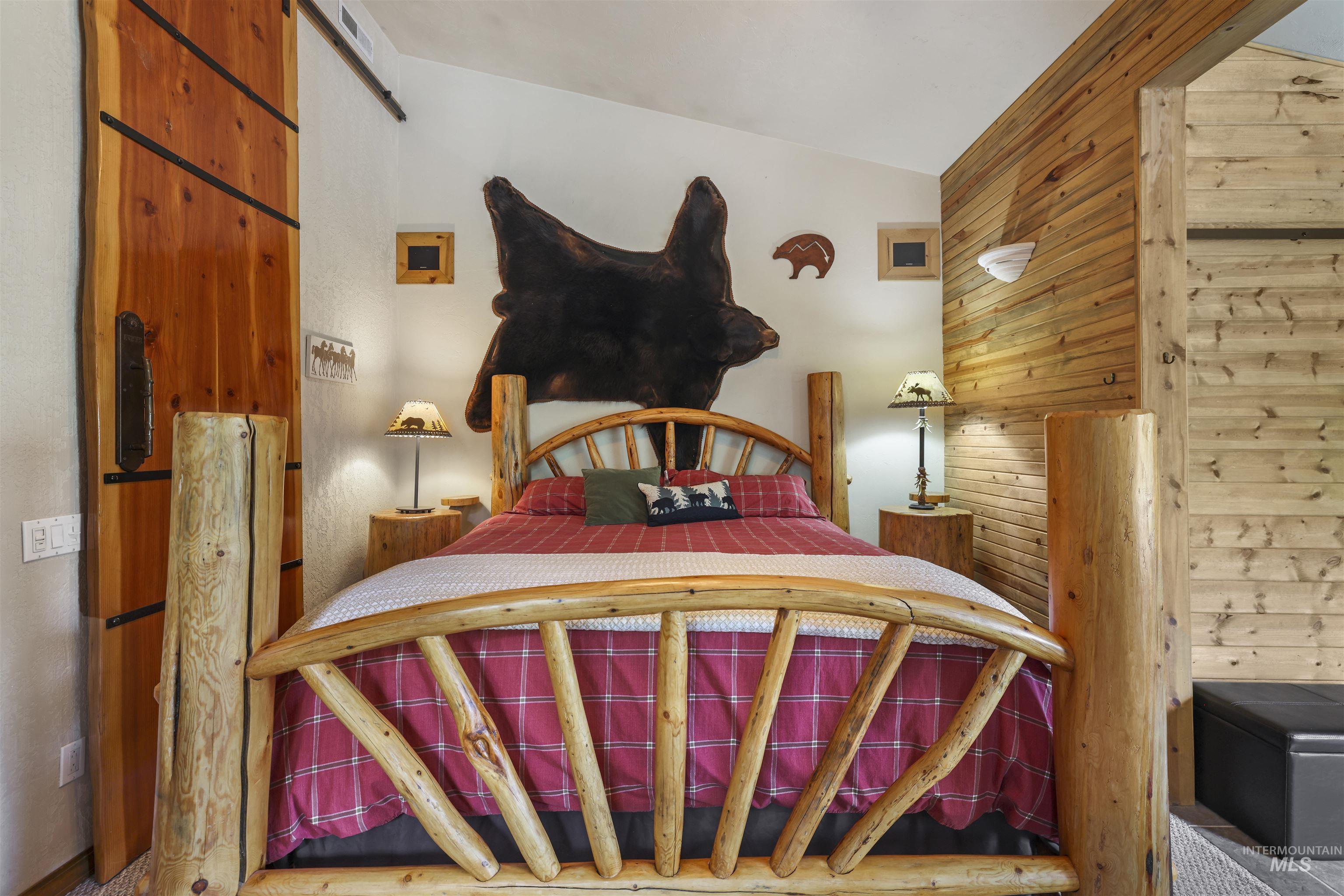 224 Dakota Road Mountain Home, ID 83647 - Photo 17 of 50 Wood-finish wall paneling complements a log-style bed frame