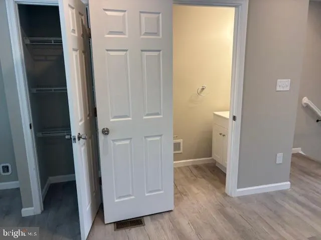 a kitchen with kitchen island granite countertop a stove a sink and a microwave