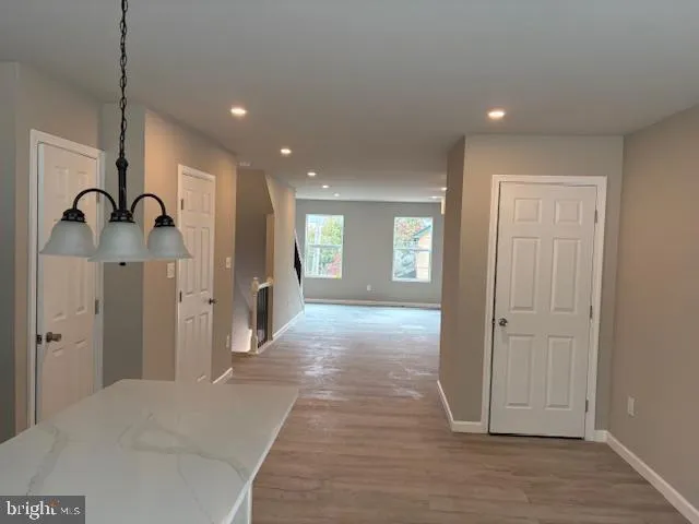a view of a kitchen with a refrigerator and a window