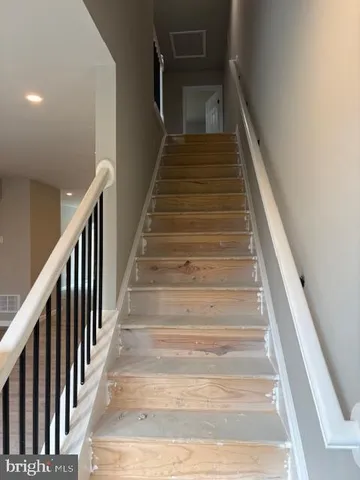 a view of a small space with wooden floor and a window