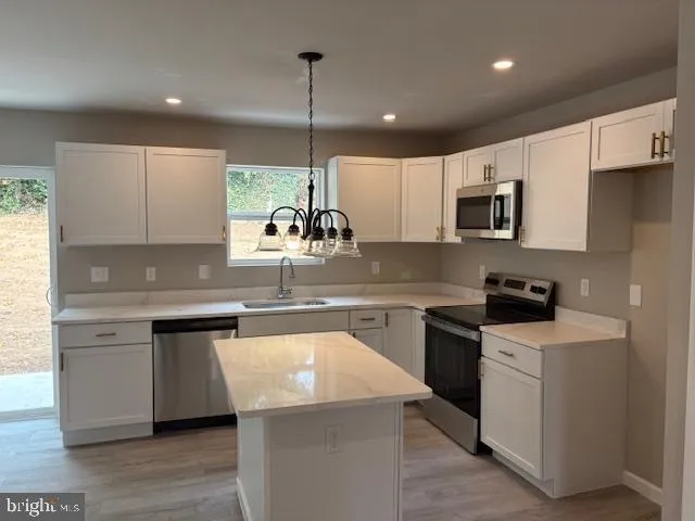 a kitchen with a sink stove and microwave
