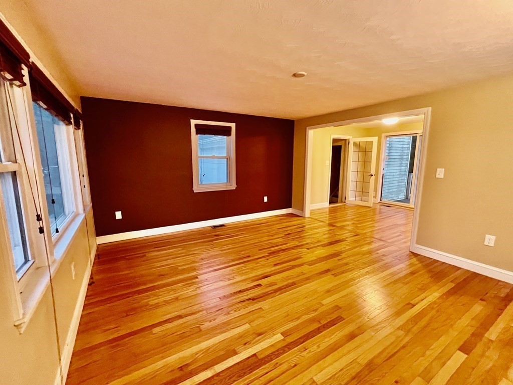 11 Lindsay Road Billerica, MA 01821 - Photo 2 of 17 a view of an empty room with wooden floor and a window