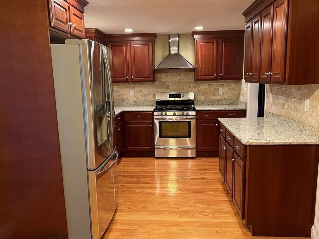 11 Lindsay Road Billerica, MA 01821 - Photo 4 of 17 a kitchen with stainless steel appliances granite countertop a refrigerator a stove a sink and a microwave