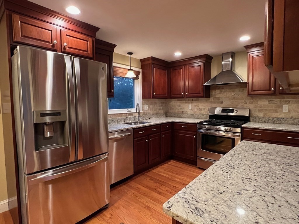 11 Lindsay Road Billerica, MA 01821 - Photo 5 of 17 a kitchen with granite countertop stainless steel appliances and wooden cabinets