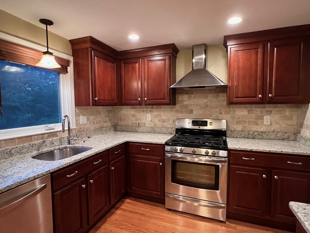 11 Lindsay Road Billerica, MA 01821 - Photo 6 of 17 a kitchen with a sink stove and cabinets