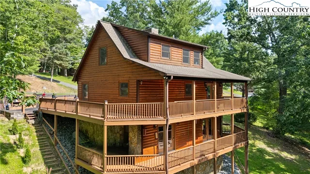 a living room with furniture a flat screen tv and a large window