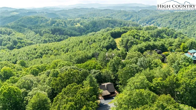 a aerial view of a house with a yard and sitting area