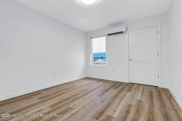 a view of room with wooden floor