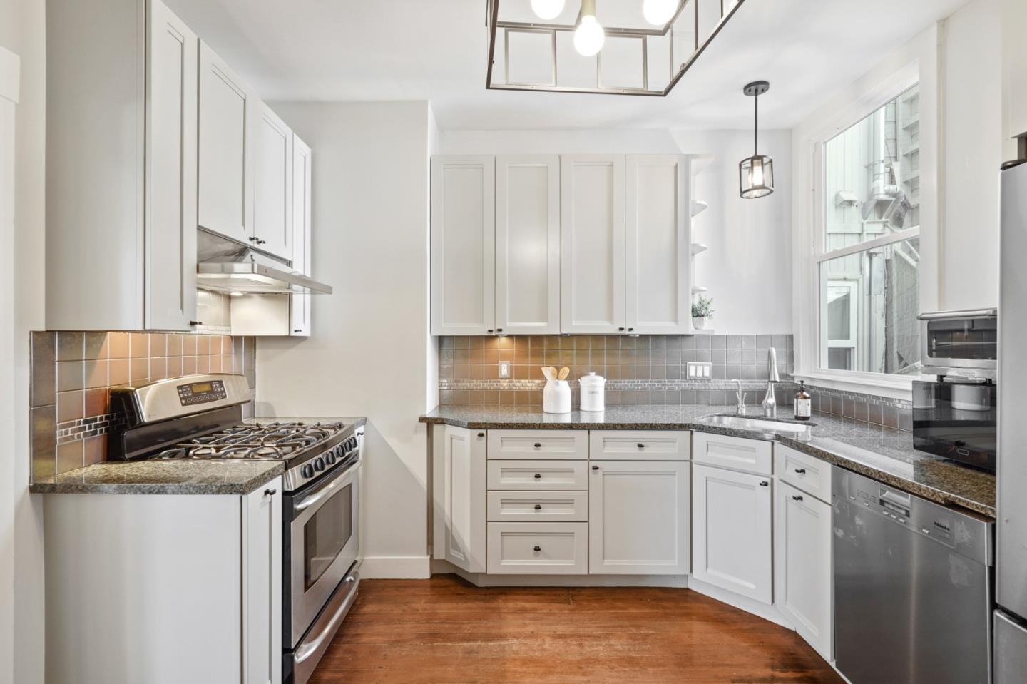 809 Masonic Avenue San Francisco, CA 94117 - Photo 14 of 30 a kitchen with stainless steel appliances granite countertop a sink stove and cabinets