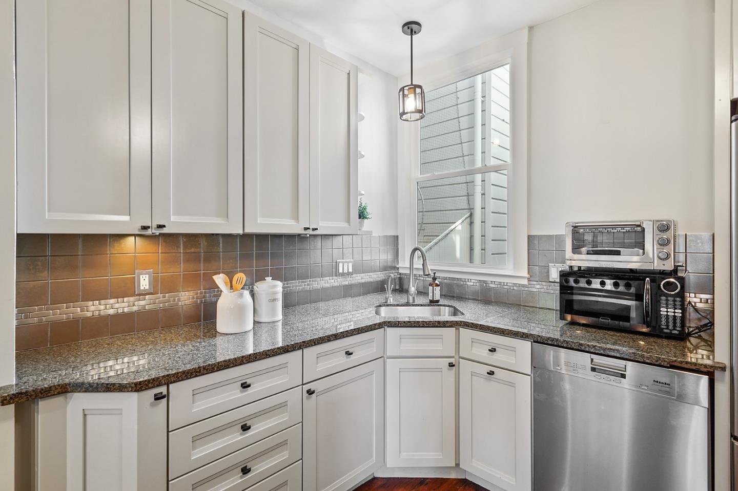 809 Masonic Avenue San Francisco, CA 94117 - Photo 15 of 30 a kitchen with appliances a sink and cabinets