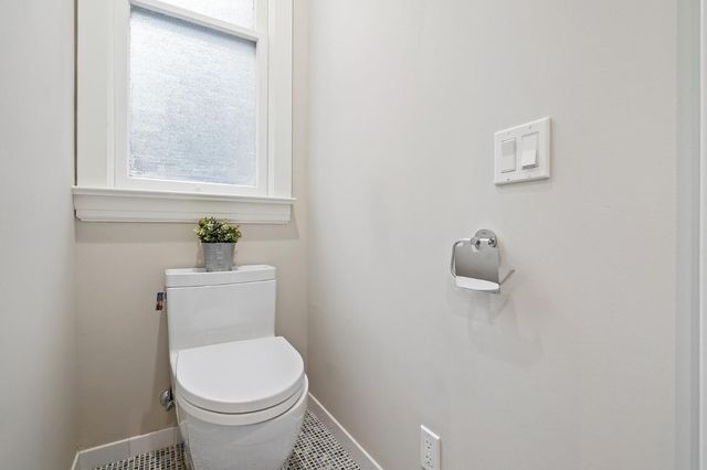 a white toilet sitting next to a window