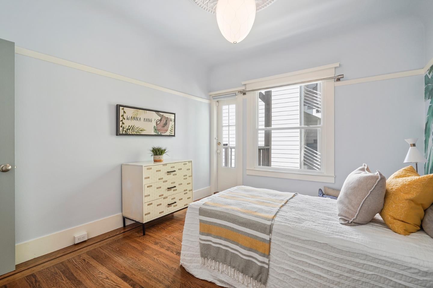 809 Masonic Avenue San Francisco, CA 94117 - Photo 21 of 30 a bedroom with a bed and a dresser