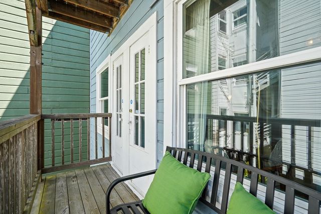 a view of a balcony with furniture