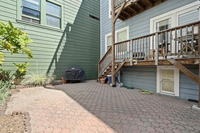 a view of a house with backyard and sitting area