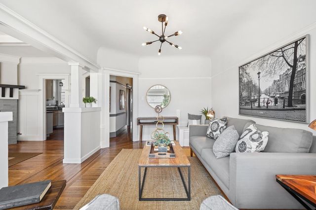a living room with furniture and a clock