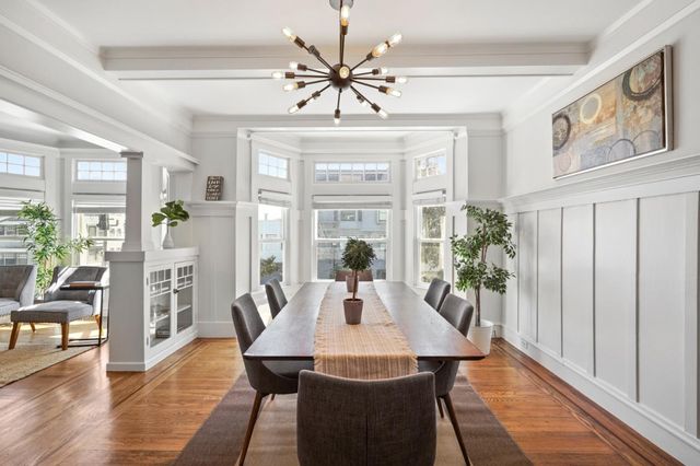 a view of a dining room with furniture window and wooden floor