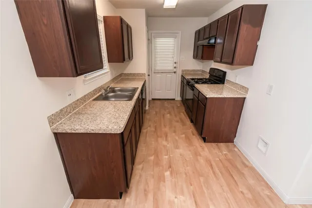a room with wooden floor and furniture