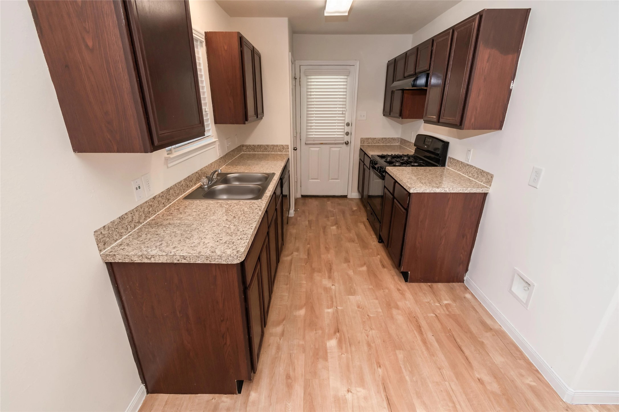 a room with wooden floor and furniture