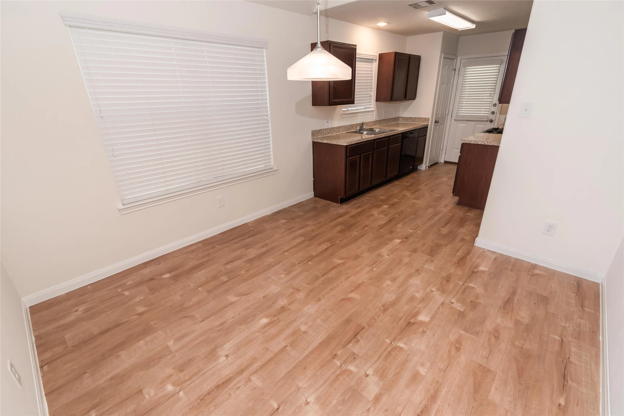 13338 Ella View Lane Houston, TX 77067 - Photo 2 of 8 a large white kitchen with granite countertop a sink