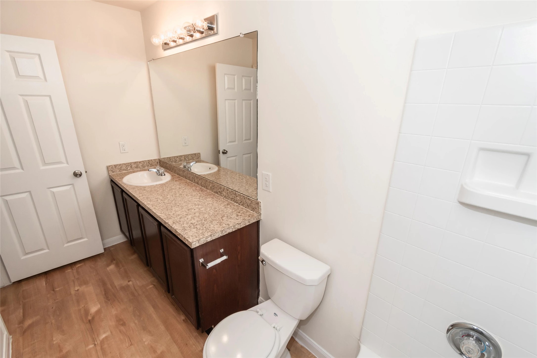 13338 Ella View Lane Houston, TX 77067 - Photo 6 of 8 a bathroom with a granite countertop toilet sink and mirror