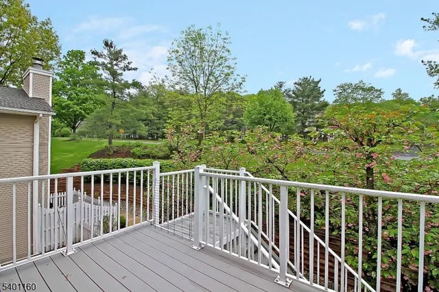 a view of balcony with wooden floor and fence
