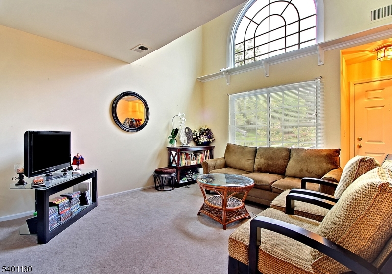62 Bentley Court Bedminster, NJ 07921 - Photo 4 of 15 a living room with furniture a flat screen tv and a window