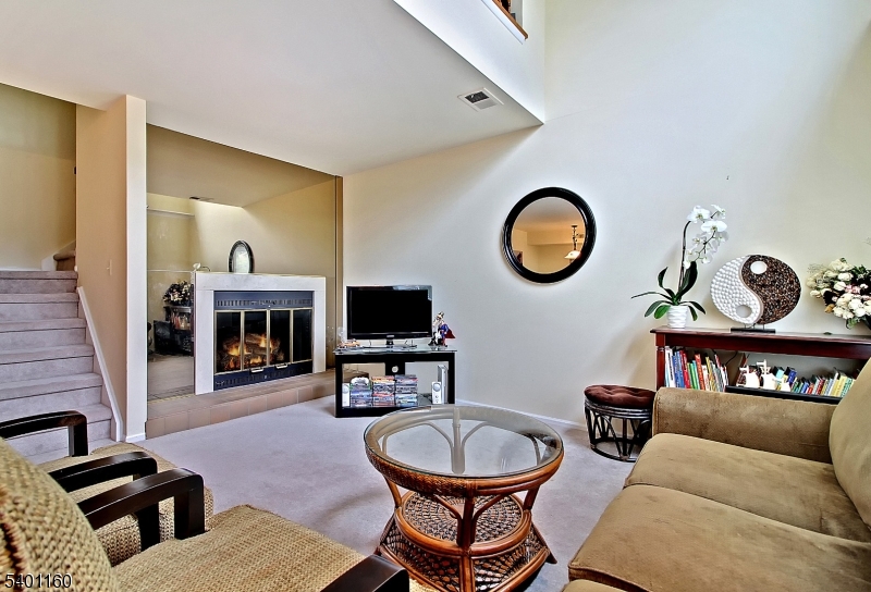 62 Bentley Court Bedminster, NJ 07921 - Photo 5 of 15 a living room with furniture a fireplace and a flat screen tv