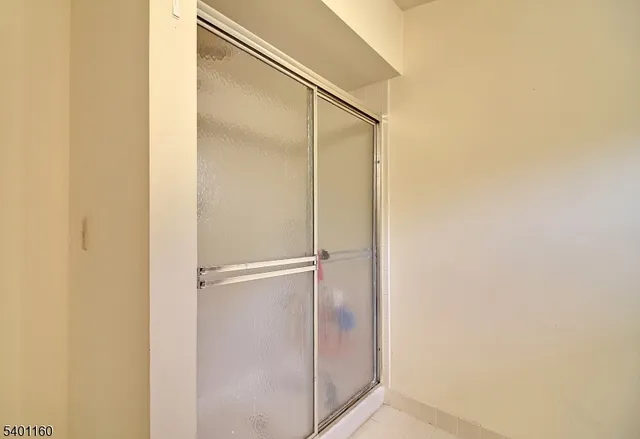 a bathroom with a glass shower door