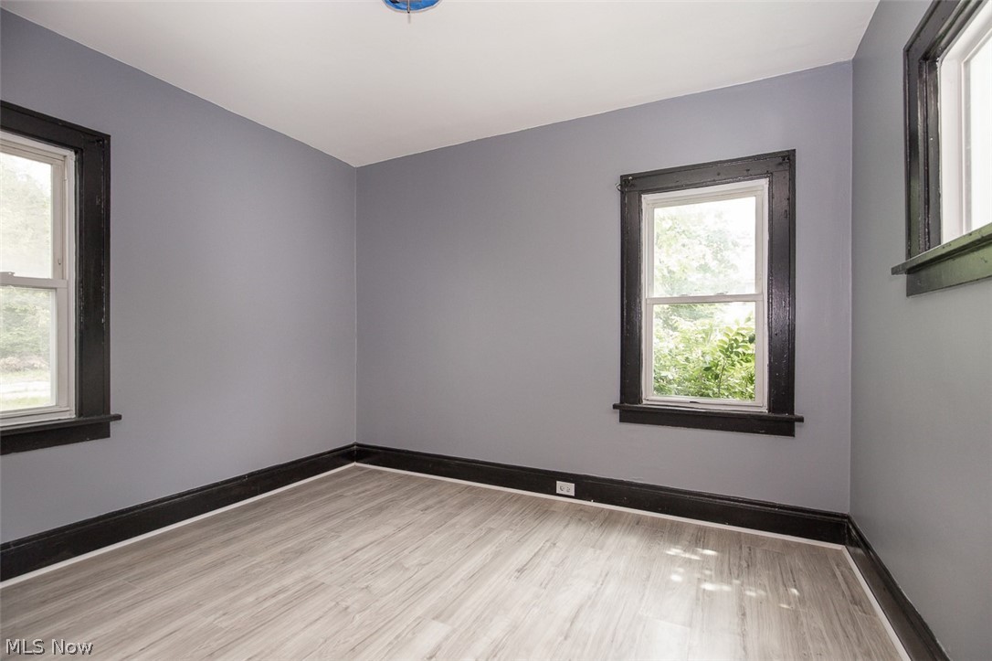 1868-1870 Lampson Road Cleveland, OH 44112 - Photo 34 of 36 Room featuring light gray wall paint, dark window trim, dark baseboards, and wood-finish flooring