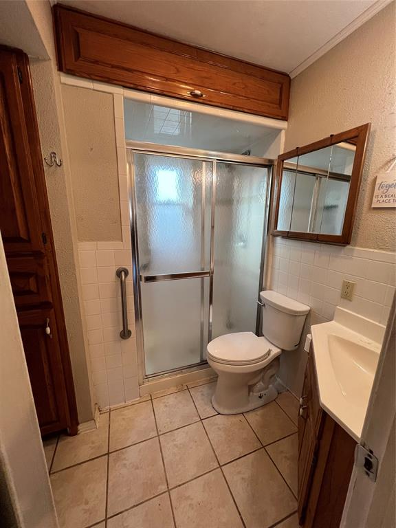 909 Rindie Street Irving, TX 75060 - Photo 11 of 18 a white toilet sitting next to a bathroom sink