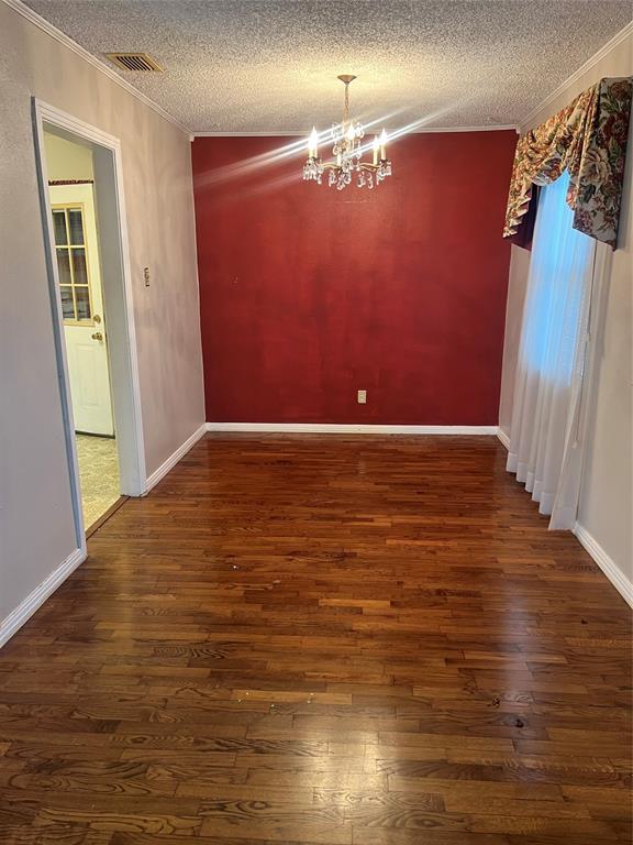909 Rindie Street Irving, TX 75060 - Photo 3 of 18 a view of empty room with wooden floor