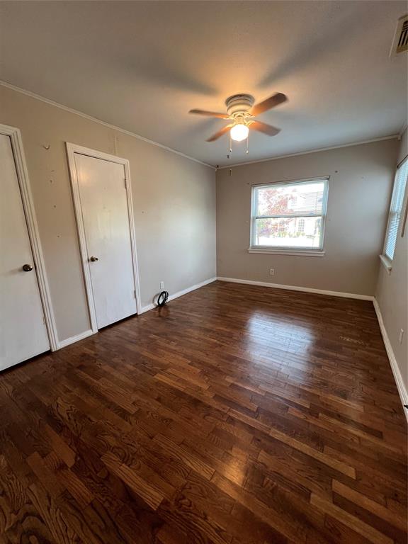 909 Rindie Street Irving, TX 75060 - Photo 8 of 18 a view of empty room with window and wooden floor