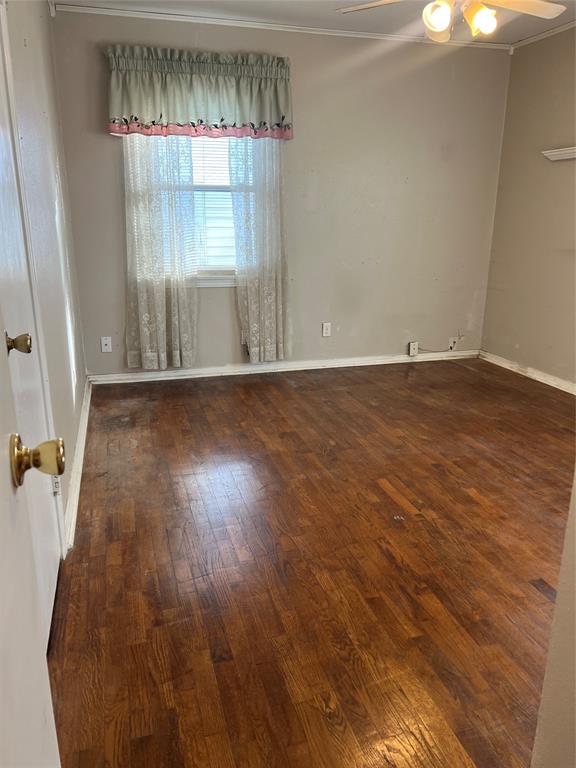 909 Rindie Street Irving, TX 75060 - Photo 10 of 18 an empty room with wooden floor and windows