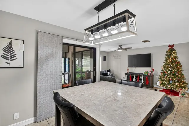 a view of a dining room with furniture and a flat screen tv