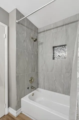 a bathroom with a bathtub and shower