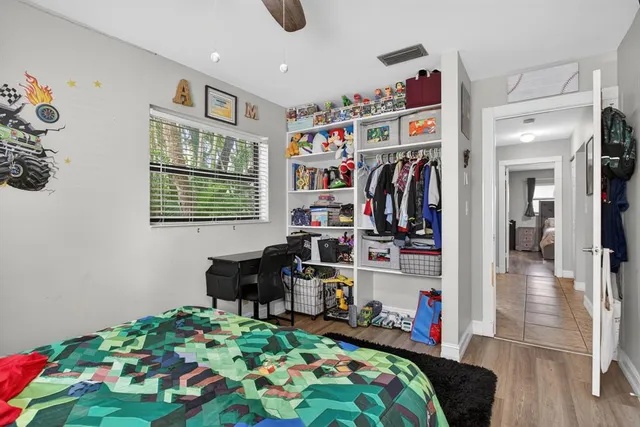 a bedroom with furniture and a book shelf