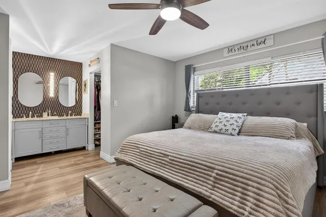 a bedroom with a sink and a mirror