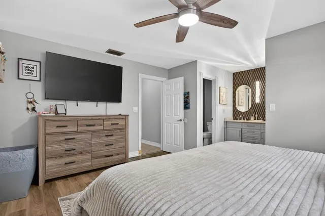 a bedroom with a bed and a flat screen tv