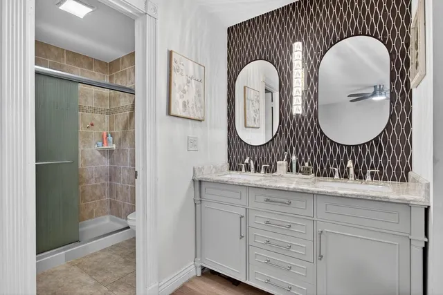 a bathroom with a mirror a sink and a shower