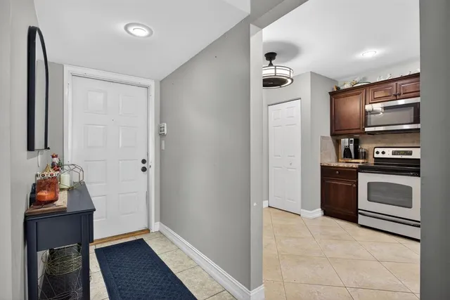 a kitchen with a refrigerator and a stove top oven