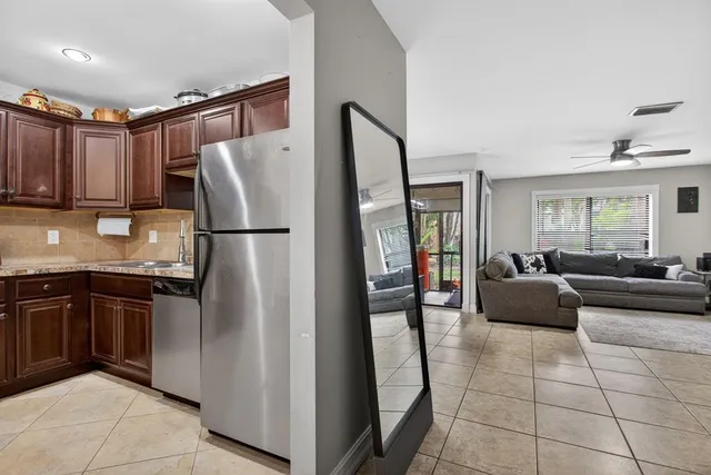 a kitchen with stainless steel appliances granite countertop a refrigerator and a sink