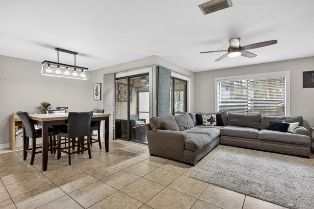 a living room with furniture a chandelier and a window