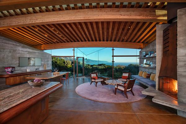 an outdoor sitting area with furniture and umbrella