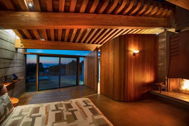 a bedroom with a bed and large window