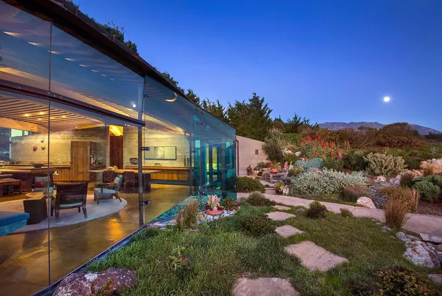 a backyard of a house with yard table and chairs