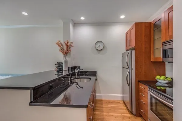 a kitchen with stainless steel appliances a refrigerator and a stove top oven