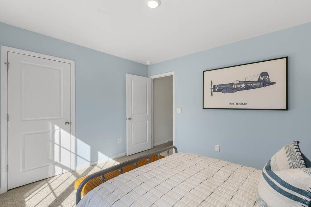 1000 Octans Way Wendell, NC 27591 - Photo 27 of 41 a bedroom with a bed and a painting on the wall